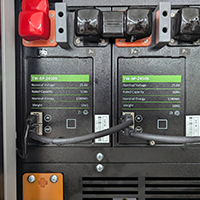 Cable connections and ports on the back panel of industrial equipment.